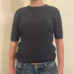 Mörkblå ribbad tröja - Säljer en snygg mörkblå lite glittrig ribbad tröja med korta ärmar. Perfekt för både vardag och fest! Tröjan har en tight passform och är superbekväm. Passar perfekt till jeans eller kjol. Hör av dig vid intresse! 💙