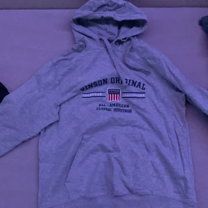 Grå mjukisbyxor från Winson Original - Säljer ett par grå mjukisbyxor från Winson Original. De har en avslappnad passform med snörning i midjan och trycket '23' på ena benet. Perfekta för en chill dag hemma eller en snabb tur till affären. Superbekväma och stilrena!