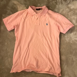Rosa Ralph Lauren Piké - Tja! Säljer en tvärfet rosa pikétröja från Ralph Lauren. Skick 9/10. Inte använd mycket men finns ett litet hål vid magen, bild finns i dm. Nypris 1400🍾. Hör av er vid frågor å funderingar 👍