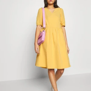 Ny klänning från Monki, S - Helt ny klänning från Monki i superhärlig gul färg med prislappen kvar, endast testad. Hämtas i Ursvik, Sundbyberg eller skickas mot fraktkostnad. 