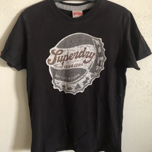 Superdry Classic Soda Cap Tee - Superdry Classic Soda Cap T-Shirt  Size small, men’s fit.  Great condition, no flaws or damage.  DM if you need exact size measurements.   Buyer pays for all shipping costs. All items sent with tracking number.   No swaps, no trades, no offers. 
