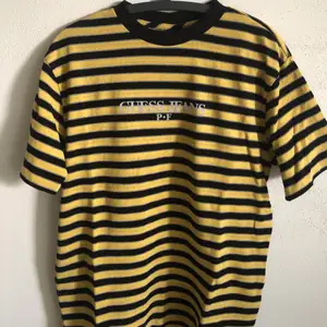 Unisex Guess Jeans x Places + Faces 3M Reflective Striped T-Shirt  Size medium, men’s size medium / large fit, slightly oversized.  Great condition, no flaws or damage.  DM if you need exact size measurements.    Buyer pays for all shipping costs. All items sent with tracking number.   No swaps, no trades, no offers. 