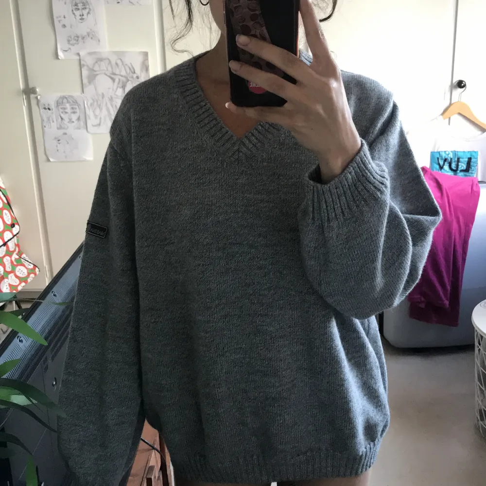 grey knitted warm and comfortable sweater. Stickat.