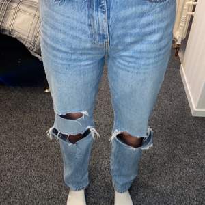 Ett par högmidjade vida jeans från Gina tricot med hål i knäna. Hålen är lite slitna med inget fel på de, går till fotknölarna på mig som är 171cm. Nypris: 599 köparen står för frakten😁