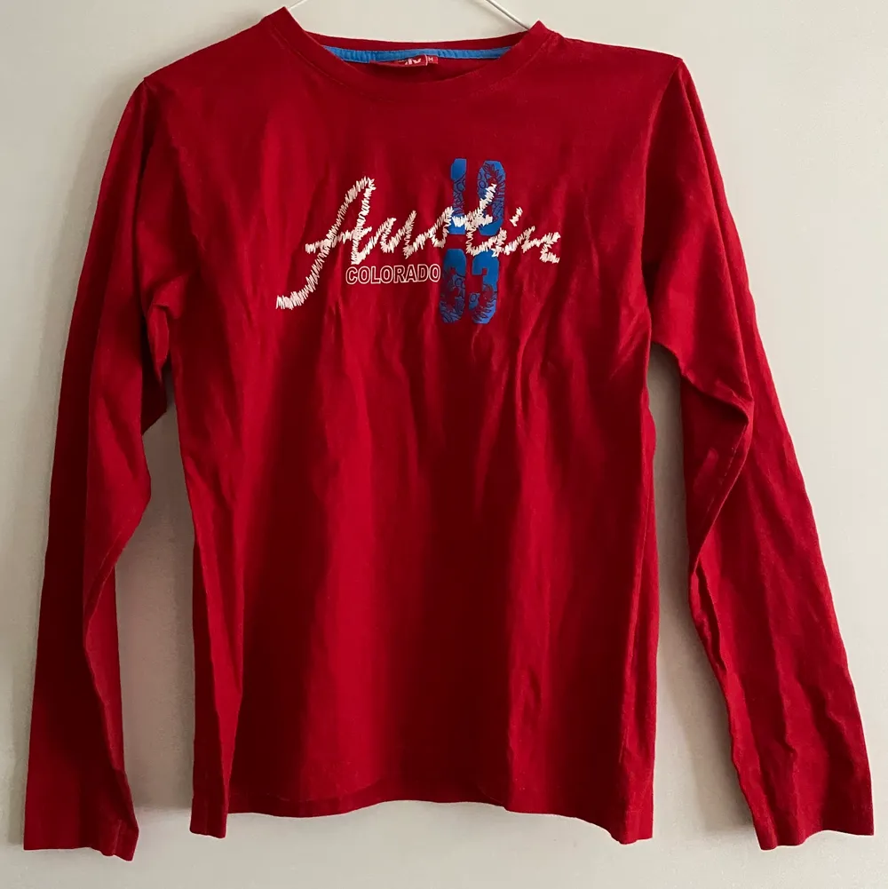 En röd långärmad tröja, där det står ”Austin Colorado 1933” på bröstkorgen, i storlek S. Eventuell frakt betalas av köparen . Tröjor & Koftor.