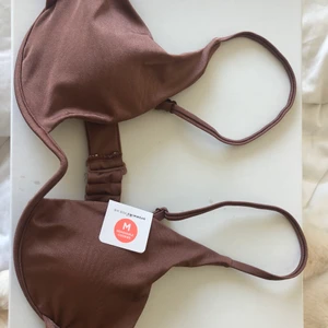 Brun trendig bikinitopp - Brun/lila bikini från bikbok med prislappen kvar. Aldrig kommit till användning då den inte är min stil. Stl M nypris 180 men säljer för 120
