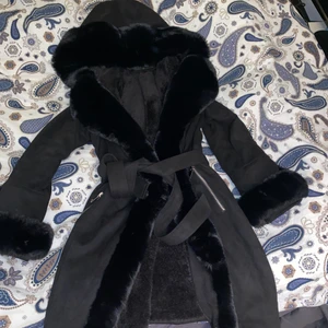svart kappa med päls  - köpte den här jackan vintern 2020 men bara använd 2 gånger. superfin pälsjacka med knytning i midjan. materialet på jackan är vegansk mocka och det är fuskpäls. Jackan är liten i storleken. säljer den pga den inte kommer till användning tyvärr. Den kostar 1500kr ny så kommer inte gå under 800kr😊