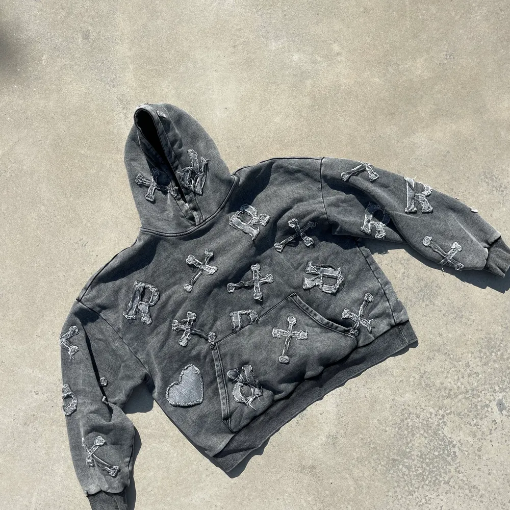 Long sleeve hooded sweatshirt in faded washed black. Oversized fit. Distressed denim patches all over. Pocket on front. Rib-knit cuffs and hem. The hoodie is made from 100% French terry. . Hoodies.