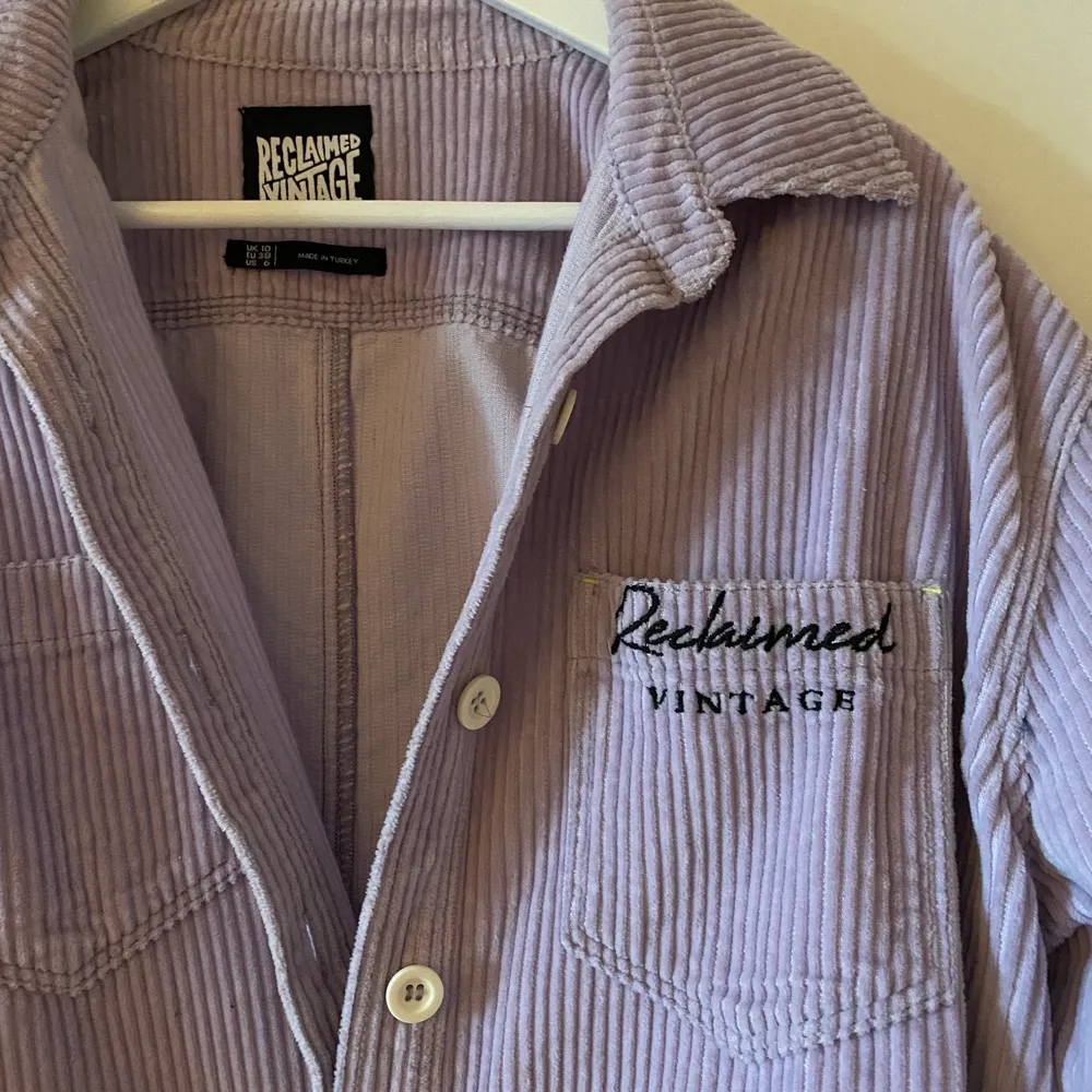 Drömmig skjorta från Reclaimed Vintage, materialet är manchester och färgen är pastellila. Passformen är oversize.Sparsamt använd, jättefint skick. Köpt för 699kr.. Skjortor.