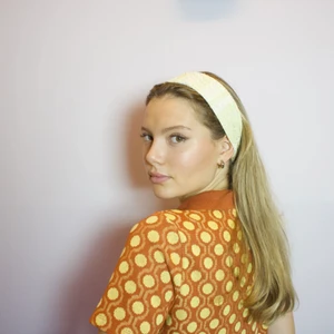 Tyg hårband  - Vi är ett UF företag som syr hårband i återvunna textiler. Det här hårbandet är i en ljusgul färg, och är sytt i ett material med vacker struktur! Hör av er för mer detaljerade bilder