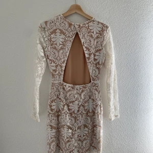 Fest klänning  - En kort klänning med spets och öppen i ryggen. 