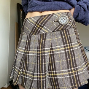 Rutig kjol - En rutig kjol i brunt och lite gult med en stor knapp på sidan. Är lite y2k stil på den och den är ganska kort. Jättegullig till sommaren! Är storlek 36 men den passar även mig som är mer mot 38.🌸✨