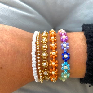 PÄRLADE ARMBAND🌈🌸💌 - Handgjorda pärlade armband - den perfekta sommaraccesoaren! Går att beställa i olika färger  - tveka inte att höra av er!!💌tillverkade med elastisk tråd & passar därmed de flesta! Se priser nedan:                                                                                 Enkelt pärlat armband (på bild: vit, vit/guld): 40kr                                         Pärlat armband med blommor🌸 (på bild: oranget, blå&ljusblå): 90kr💘Mångfärgat/guldmönstrat armband: 99kr JUST NU två 🌸armband 179kr