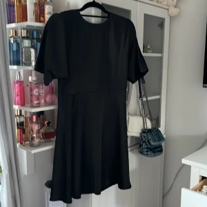 Klänning  - Jättefin svart klänning i satin. Säljer då den tyvärr inte passade mig, från monki. Öppen i ryggen. 