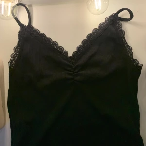 Spetslinne bikbok - Ett super sött svart linne med spets detaljer! Det är basic fast finare och passar till allt. Perfekt nu till sommaren asså💓