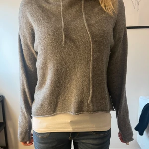 STICKAD TRÖJA!! - Säljer denna jättefina gråa tröja som har en huva!! Den är kortare fram än bak!! Köpte på sellpy men den är ifrån brandy Melville!! Står ingen storlek i tröjan, men passat mig som vanligtvis har S/M!! Väldigt bra skick!!