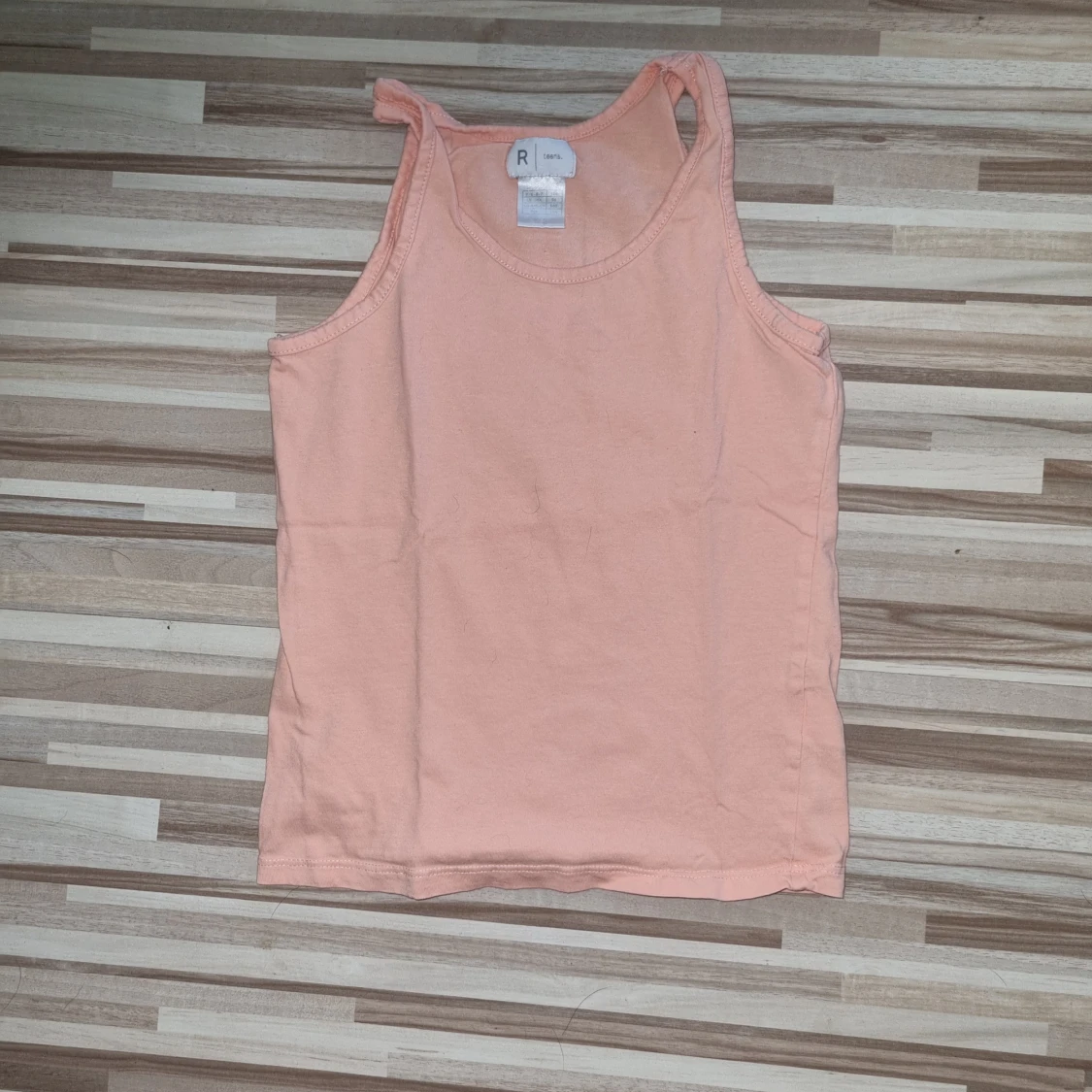 Persikofärgad linnetopp