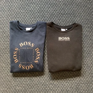 Hugo Boss sweatshirt - Två Hugo Boss sweatshirts. En marinblå och en svart, storlek 12-xs i bra skick. En för 400kr båda för 700kr