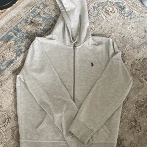 Grå Ralph lauren performance zip up  - Är i bra skick, men har blivit lite norpigt. Pris går att diskutera vid snabb affär 