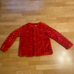 Röd Pälsjacka  - Oanvänt röd fuskpälsjacka från Saint Tropez. Ny pris 825 kr. Passar XS / L.  Kommer med extra knappar 😊