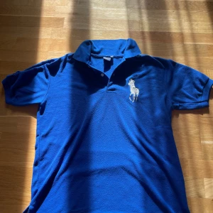 Polo Ralph Lauren piké Chief Keef - En snygg blå polo piké i jättebra skick, den är i storlek L och knappt använd. Lenght 67-68 cm  and width is like 57 cm. Skriv för fler bilder :)