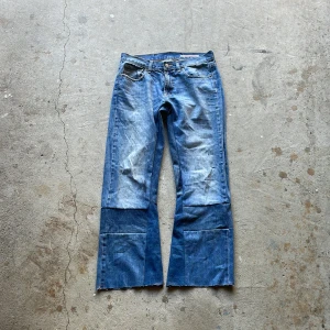 Reconstructed Flare Jeans - These jeans has been reconstructed to have a straight flared fit with distressed details.