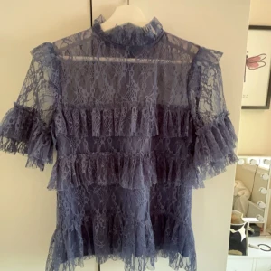 By malina blus - Blå by malina blus! Passar till typ allt. Inga defekter förrutom att lappen har lossnat på ena sidan. Storlek XS.