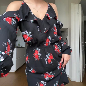 Blommig volangklänning - En jätte söt klänning med blommor. Skön att bära då den är luftig och har en mjuk material. 