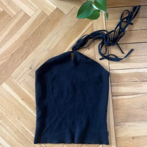 Tubtopp - Svart Tube top från Calvin Klein. Fin och unik tazzle design som kan knytas på olika sätt. Gott skick.