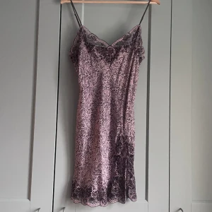 Vintage Silk Slip Dress - Vintage Silk Slip Dress with purple floral print  Pretty Lace Trim Detail   Very Good Condition  Model Is 160cm (5”3) And Generally Fits XS/S.  83 CM/ 32.7 IN Length 27 CM/ 10.6 IN Shoulders 102 CM/ 40.2 IN Waist
