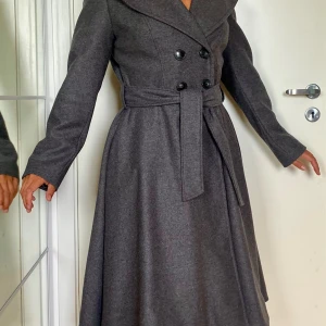 Virgin Wool Flared Coat - New without tags, in original garment bag, with original wooden hanger.  Used once only for a photoshoot.  The coat is from 2020 and made in Poland (EU).  Great quality, nicely sewn, pretty flared design. It was a gift from the brand.