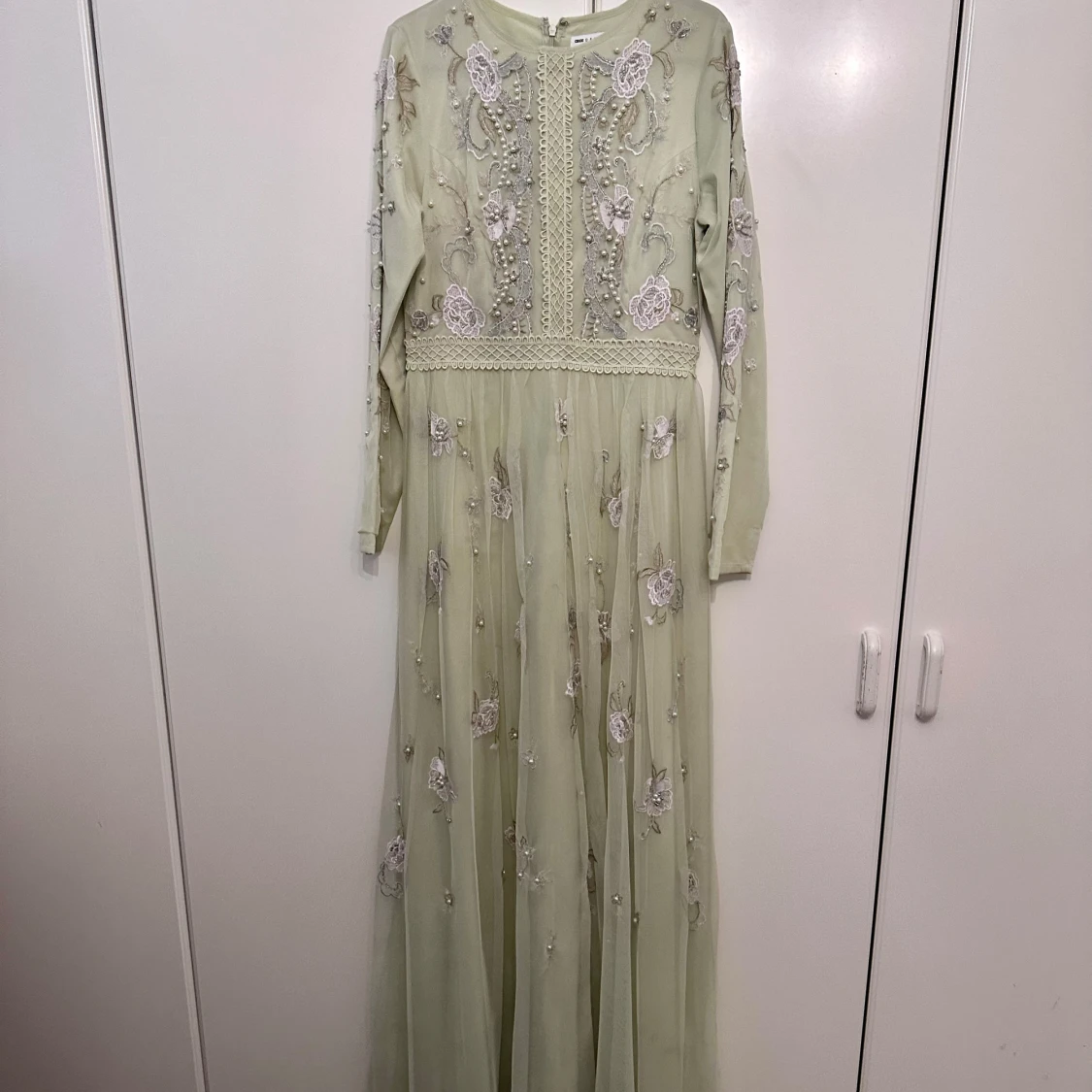 Ljusgrön klänning med pärldekorationer