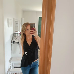 Halterneck topp - Svart halterneck topp med knytdetalj i nacken med öppen rygg  Aldrig använd