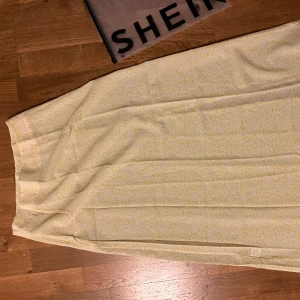 Sommarkjol från Shein💛 - Söt vadlång sommarkjol från Shein, gul med vita blommor, sprund från mitten på låret, storlek S. Aldrig använd. Prisförslag. Frakt tillkommer 