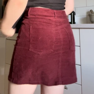 Red-burgundy skirt  - Soft material and its a good balance between rigid and stretchy, so its comfy to wear and sit. 