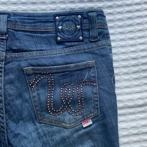 Tajta jeans med detaljer  - Jeans med detaljer på fickorna samt så har de dragkedja vit anklarna, man kan dra upp och ned de. Det står ingen storlek men skulle gissa på 25/30