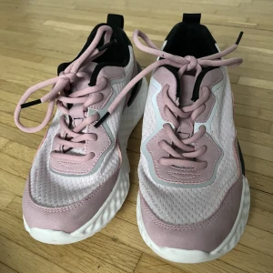 Rosa gympaskor - Rosa och svarta gympaskor med reflex på i storlek 39, köpta på skopunkten. Använda Max en gång.