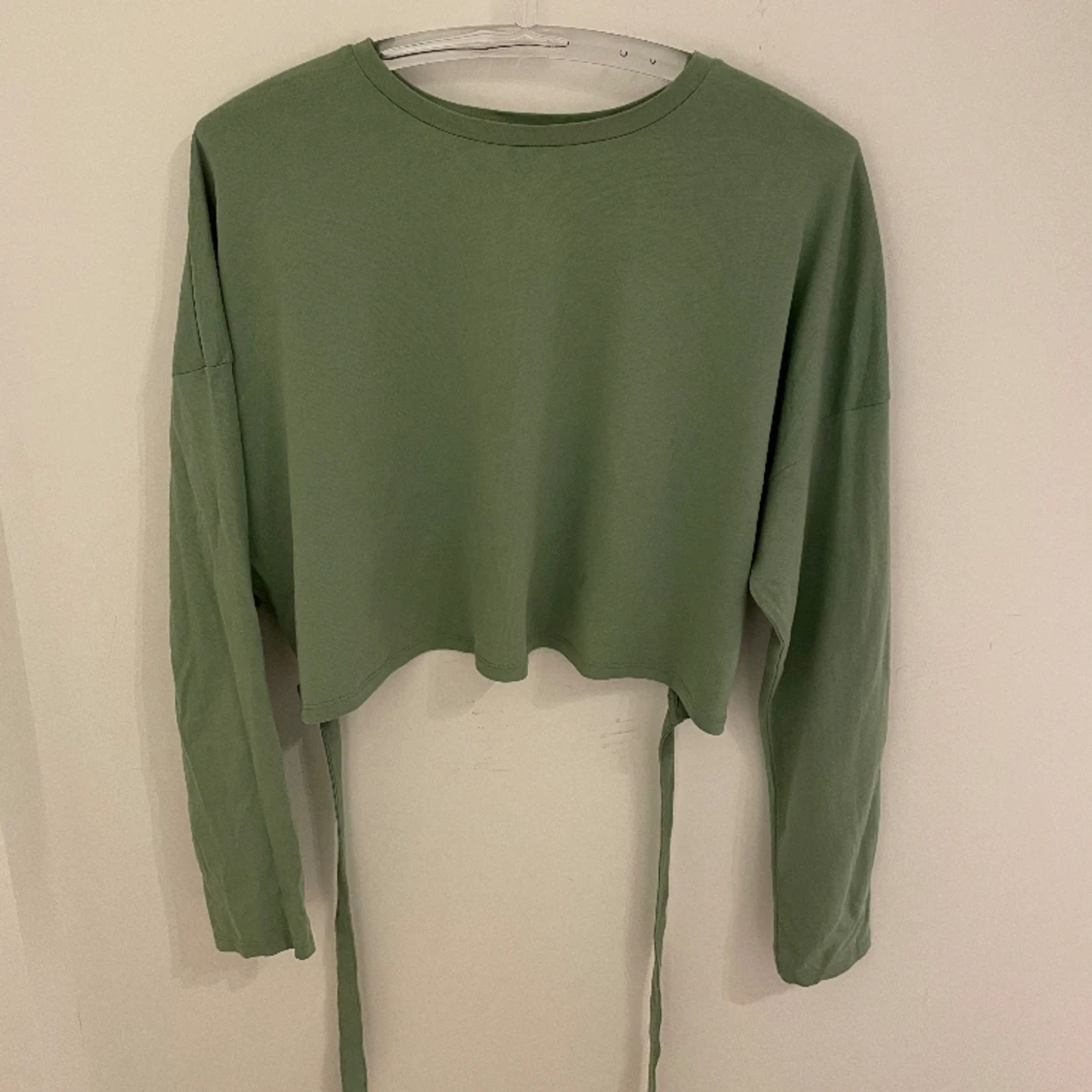 Grön topp med knytbar rosett 