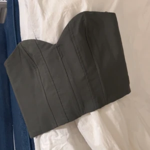 Grön korsett topp från Zara💚 - Säljer denna helt oanvända korsett topp från Zara, alltså är den i nyskick!💚