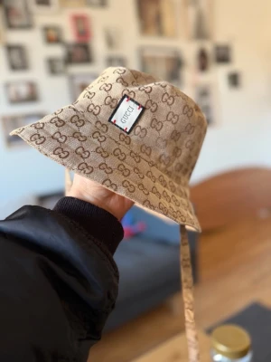 2-in-1 Reversible Designer Style Bucket Hat - Selling this beautiful, high-quality bucket hat. The best part? It’s fully reversible! 🔄 • Exterior: Iconic monogram print on premium canvas material. • Interior: Soft, plain beige lining—wear it inside-out for a completely different look. • Details: Comes with long adjustable straps that can be tied or left hanging for a trendy look. • Quality: Excellent craftsmanship, sturdy stitching, and beautiful fabric texture. Carefully stored in a smoke-free home. Fast shipping guaranteed! 📦 