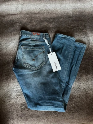 Dondup George - Tja säljer nu ett par dondup jeans i modellen George. Det är storlek W32 och skicket är 10/10. Det är inte använda och tagen finns kvar. Pris är endast 699kr. Färgen är en ljusare blå perfekt till våren/sommaren. Skriv vid minsta fundering!🔥