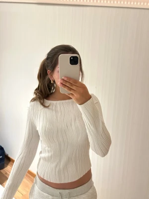 Vit ribbad långärmad tröja - Säljer en vit långärmad tröja med ribbat mönster och rund halsringning. Aldrig använd