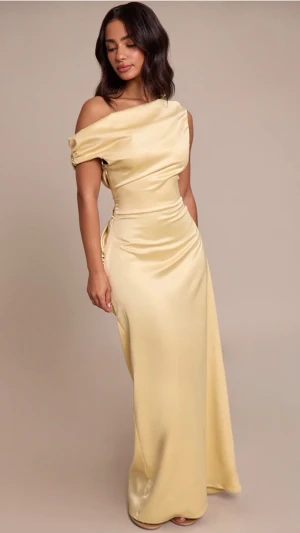 Långklänning PTL - Gul långklänning från Pretty Little Thing, storlek 6  Petite, men som en Xs/XXS, skulle jag säga. Jag är 155 och den är för lång för mig.  färgen är inte lika gul som på bild, färgen heter butter yellow så den är inte lika gul som bilden men fortfarande gul, kan skicka bild på den om man vill. säljer för att den är för liten. den är inte använd alltså. prislapp och allt sitter kvar!