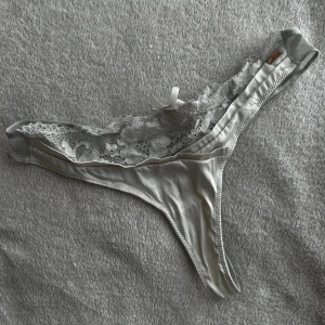 Vita spets-trosor med rosett - Florencia string. Ny pris 310kr.