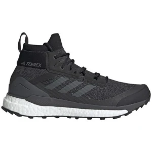 Svarta Terrex kängor från Adidas - Säljer ett par svarta Adidas Terrex kängor med högt skaft och snörning. Skorna har en robust sula med bra grepp, diskreta ränder på sidan och är tillverkade i slitstarkt textil- och syntetmaterial. Perfekta för utomhusaktiviteter och streetwear.