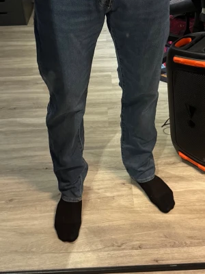 Mörkblå jeans från Jack & Jones - Snygga mörkblå jeans från Jack & Jones med klassisk femficksdesign och raka ben. Jeansen har normal midja och är tillverkade i ett mjukt denimtyg med lite stretch för extra komfort. Storlek 32/34