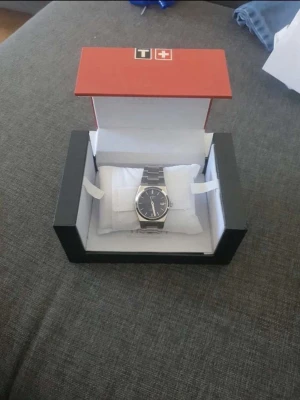 Tissot PRX daydate klocka - Snygg Tissot PRX klocka i rostfritt stål med blå urtavla och datumvisning. Klockan har ett klassiskt armband i metall och stilren design som passar till allt. Levereras i originalask. Helt nya aldrig användna