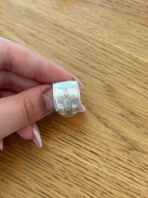 Bred silverring - Cool bred ring i silver med en detaljerad skalbagge ingraverad på framsidan. Ringen har en unik och chunky design som verkligen sticker ut och passar dig som gillar att uttrycka din stil med accessoarer.