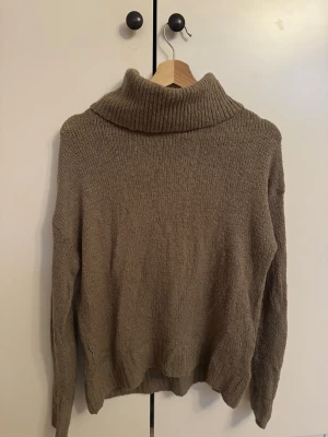 Beige stickad polotröja - Mysig beige stickad polotröja med hög krage och långa ärmar. Materialet känns mjukt och värmande, perfekt för kyliga dagar.❤️