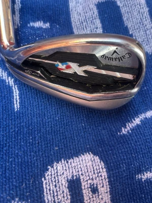 Callaway X golfklubba Pitching Wedge - Säljer en Callaway X Pitching Wedge golfklubba i metall med svart och silver detaljer. Klubban har en tydlig X-logga och är designad för precision på golfbanan. Perfekt för dig som vill förbättra ditt närspel. Priset är hugget i sten de är bara att komma med förslag osv